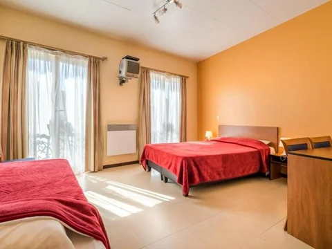 Kamer met bed en gordijnen van Hotel The Moon, Brussel